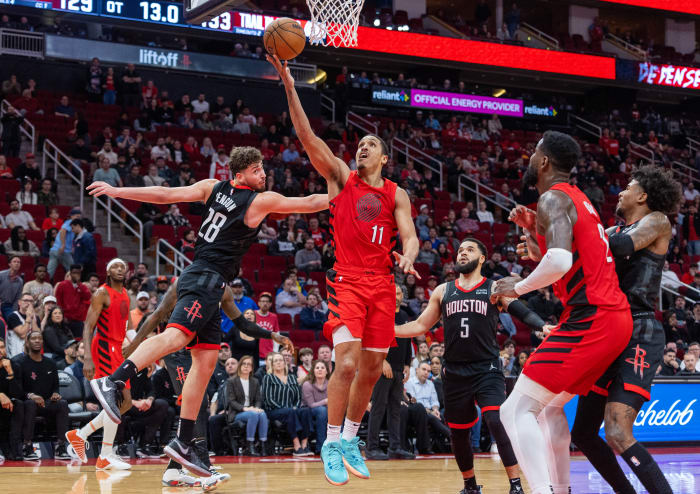 Trail Blazers guard Malcolm Brogdon shoots against Houston Rockets center Alperen Sengun in overtime at Toyota Center.